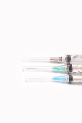 Fototapeta premium Three medical syringe closeup on white background isolated