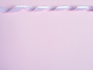 Pink ribbons on pink background Copy space