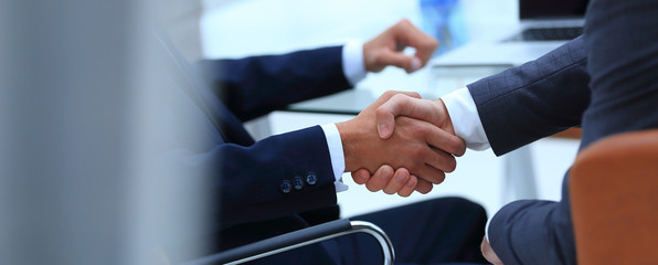 handshake of business partners on blurred background