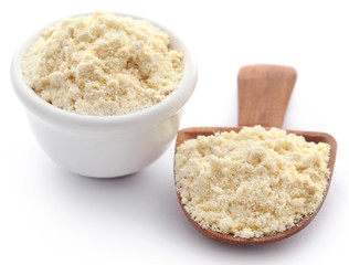 Gram flour in bowl and wooden scoop