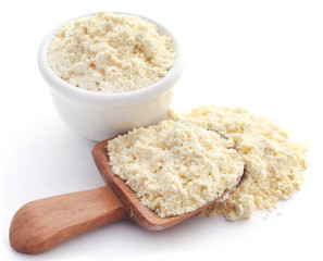 Gram flour in bowl and wooden scoop