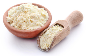 Gram flour in bowl and wooden scoop