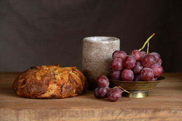 Bread, Grapes and Wine Cup on Table