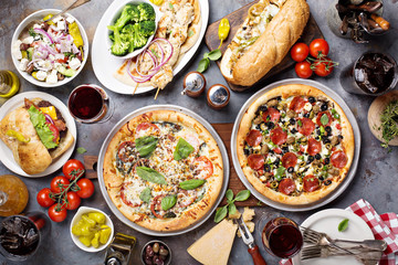 Big dinner with pizza and sandwiches