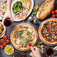Big dinner with pizza and sandwiches