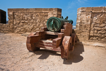 Fototapeta na wymiar Old cannon on fortified wall in Portuguese fortress Sqala du Port in Essaouira, Morocco, North Africa