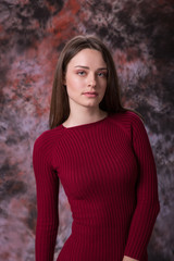Fototapeta premium Portrait of a beautiful young woman in red dress