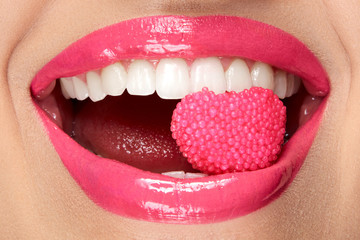 Pink Lips. Woman With Candy In Mouth.