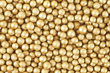 Close up of little golden balls, as background