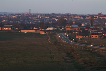 The village in the Chechen Republic, lit by rays of sunset.