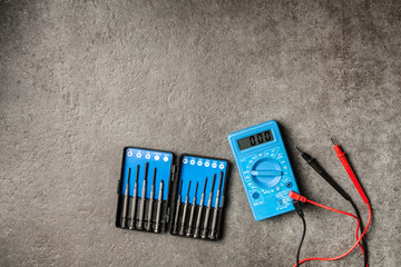 Digital multimeter on grey background