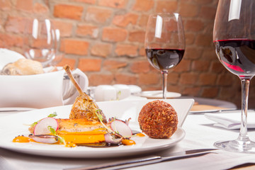 Guinea fowl, pumpkin puree, fried buckwheat, gravy sauce served in a restaurant
