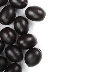 whole black olives isolated on white background with copy space for your text. Top view. Flat lay pattern