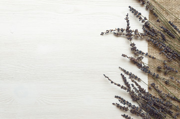 Dry lavender branches on white wooden background with copy space. Herbal medicine concept. Alternative medicine.