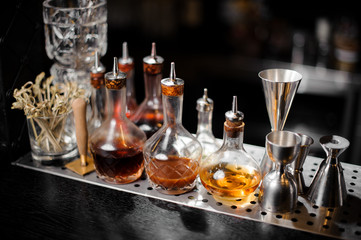 Set of bar equipment and bottles with syrups on the bar counter