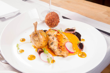Guinea fowl, pumpkin puree, fried buckwheat, gravy sauce served in a restaurant