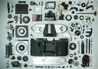 parts old retro film SLR camera on graph paper