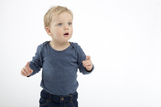 thoughtful and surpised toddler on the white background. copy space. studio shot