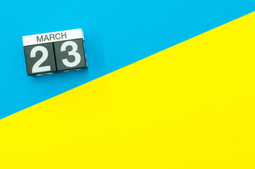 March 23rd. Day 23 of march month, calendar on blue and yellow background flat lay, top view. Spring time. Empty space for text