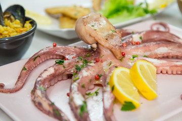 Fried fish,rice with mussels and octopus on dish with lemon and salad. Typical sicilian food