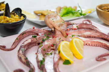 Fried fish,rice with mussels and octopus on dish with lemon and salad. Typical sicilian food