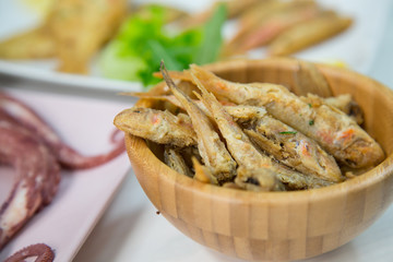 Fried fish,rice with mussels and octopus on dish with lemon and salad. Typical sicilian food