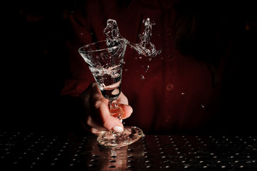 Female hand holding a cocktail glass filled with a fresh drink