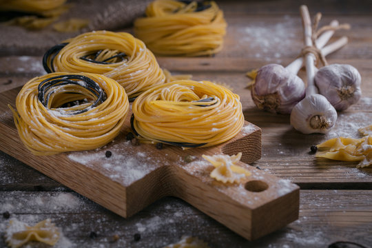 Raw homemade pasta with flour, garlic and spices