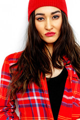 Stylish brunette girl. Casual style. Checkered shirt and beanie