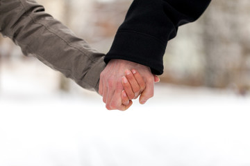 a girl is holding a male hand