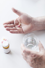 Close up of male hand holding a vitamins and supplements.