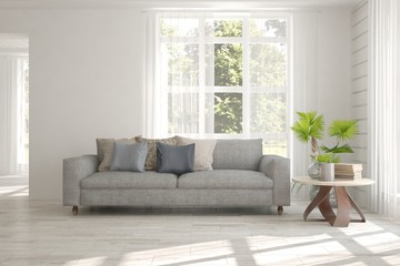 White room with sofa and green landscape in window. Scandinavian interior design. 3D illustration