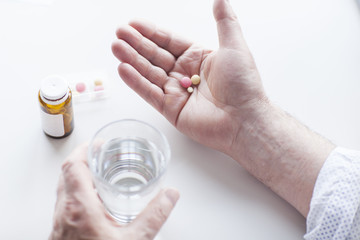 Close up of male hand holding a vitamins and supplements.