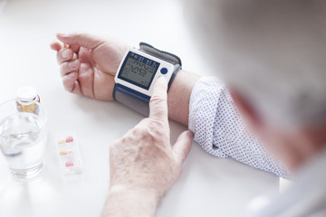 SEnior patient examining his blood pressure. Hypertension.