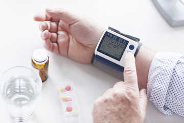 SEnior patient examining his blood pressure. Hypertension.