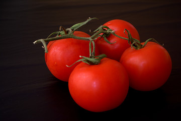 tomatoes on black background