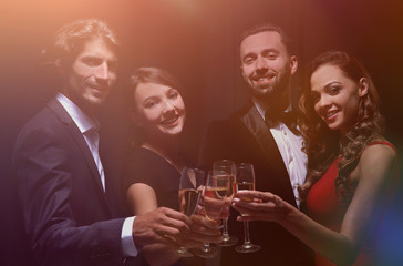 Cheerful people celebrating a sucess with Champagne