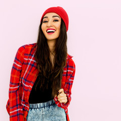Happy brunette Girl  Fashion  Checkered shirt and beanie cap. Trendy. Tomboy look