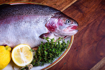 Preparation of fresh salmon with herbs and lemon.