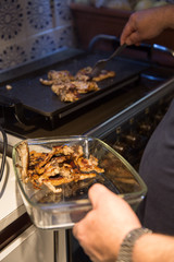 Senior man making grilled lamb chops at home. 