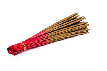 Close-up a bunch of incense sticks isolated on white. Incense use in religious ritual popular in Vietnam.Its burned to intend as a sacrificial offering to various deity or to serve as an aid in prayer © trongnguyen