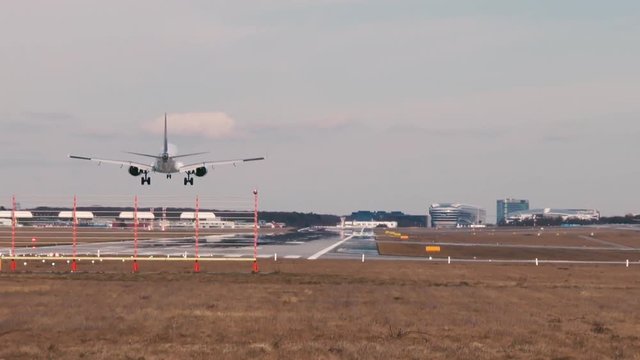 Landing airplane on runway Northwest at Frankfurt International airport.