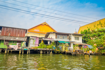 Fototapeta na wymiar Outdoor view of floating wooden poor house located on the Chao Phraya river. Thailand, Bangkok