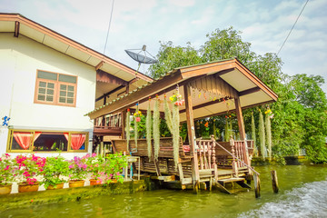 Fototapeta na wymiar Outdoor view of gorgeous floating wooden house on the Chao Phraya river. Thailand, Bangkok