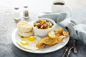 Fried fish breakfast with sunny side up eggs