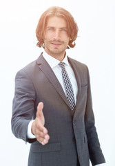 Smiling friendly businessman offers a handshake