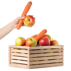 Wooden box of apples carrots female hand