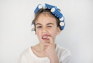 little girl posing with curlers