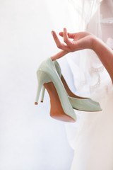  Beautiful bridal shoes mint color bride holds in hands