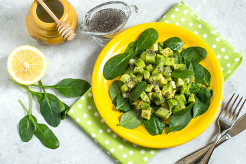 Vitamin vegetarian salad with avocado, kiwi, spinach and chia seeds